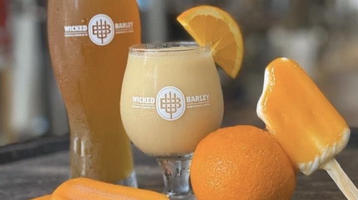 Wicked Barley Brewing Company beers and citrus dessert on a table.