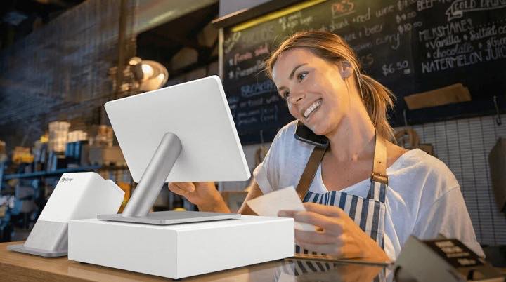 Restaurant staff member handling service and phone orders.